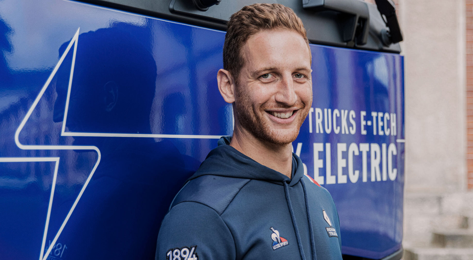 Man wearing Le Coq Sportif hoodie. Smiling.