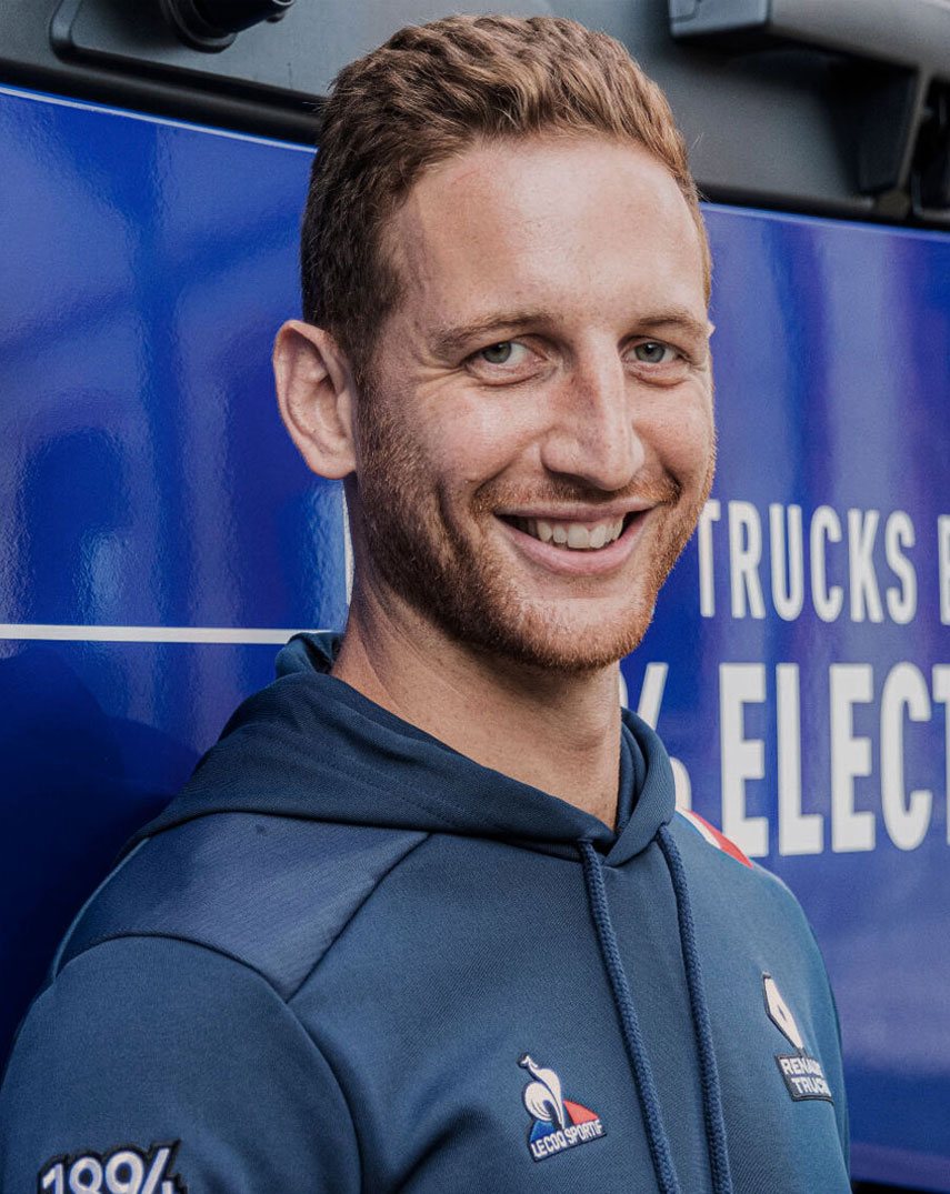 A man smiling. Wearing Le Coq Sportif hoodie.