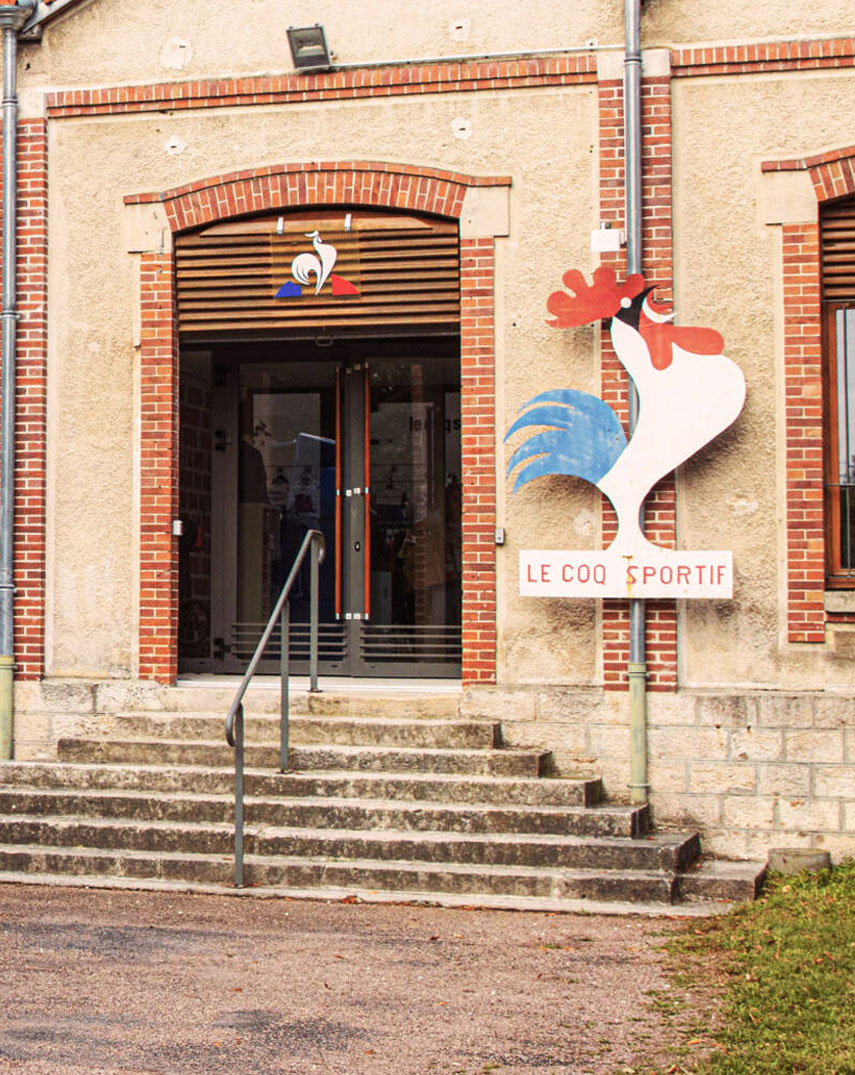 LE Coq Sportif head office with people in the front.